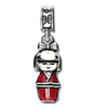 Silver charm shaped like a traditional Japanese kokeshi doll with red outfit on a white background