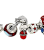A close-up of a silver charm bracelet featuring various decorative charms, including a red and blue dragon bead, a red and white figure charm, a red chest charm, and a red box charm, all set against a plain white background.
